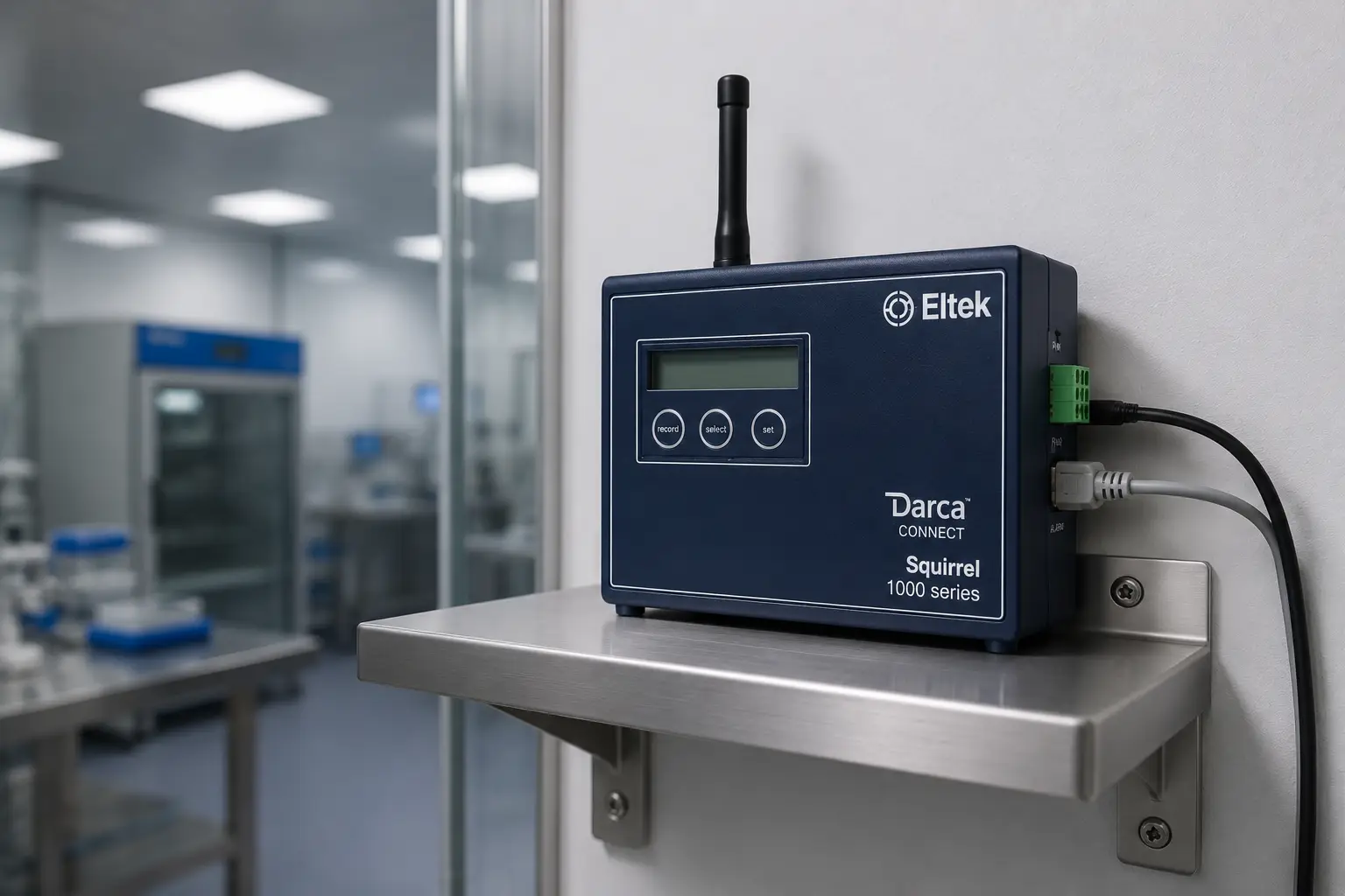A Darca Connect SRV450 wireless hub mounted on a wall bracket in a clean laboratory, gathering the monitoring network