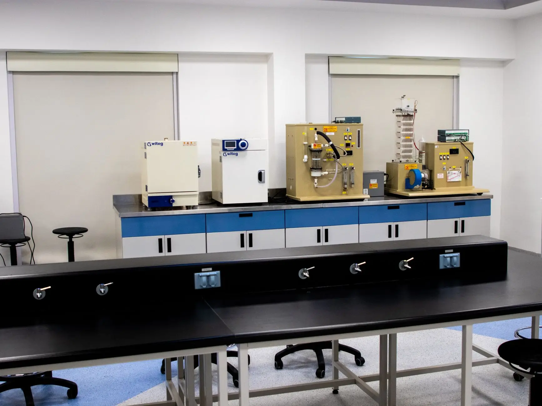 Rows of ultra-low temperature freezers in a large biobank storage facility