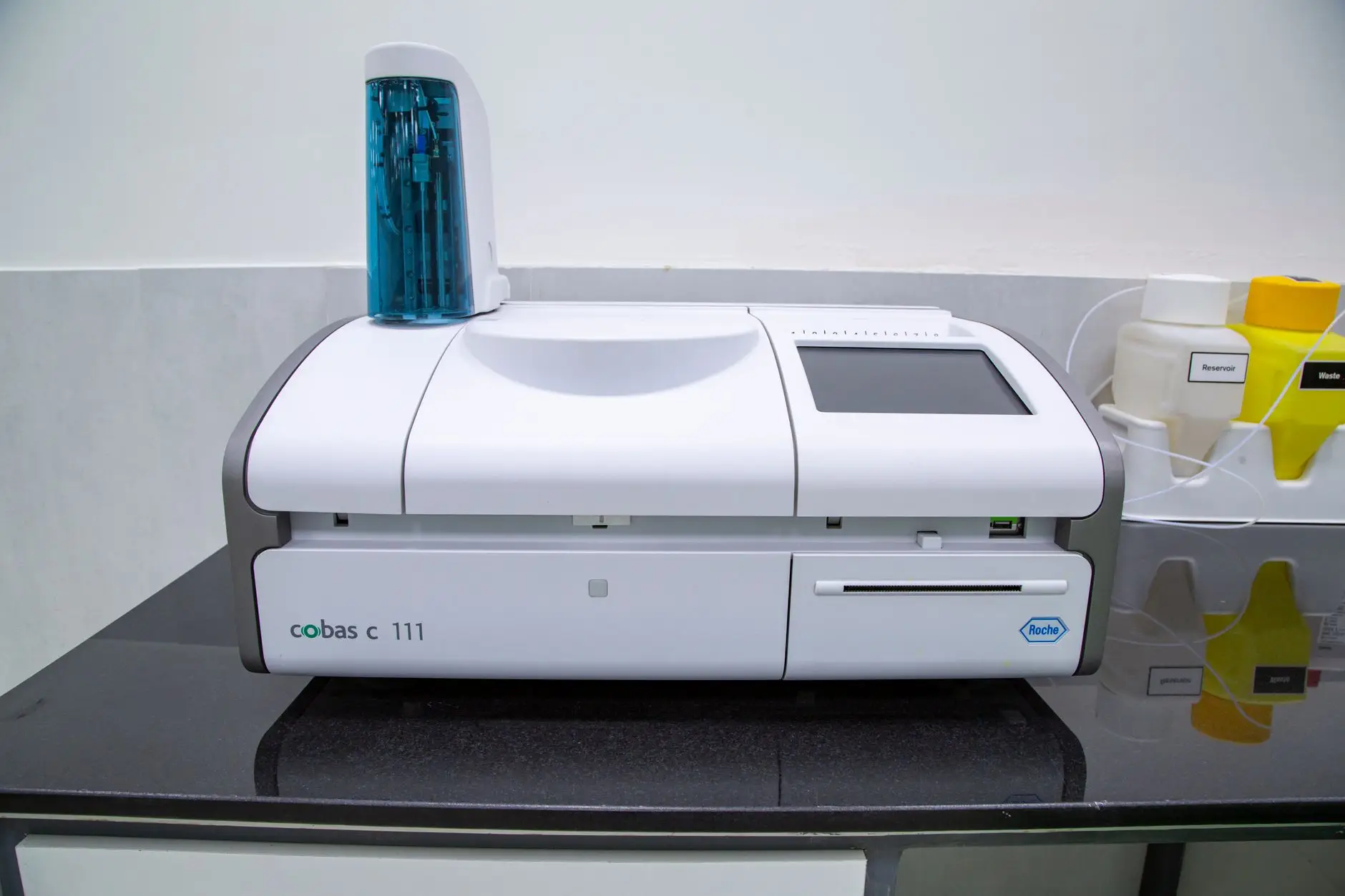 A high-throughput analyser in a clinical diagnostic laboratory, the kind of pathology environment where Eltek monitors the refrigerators, freezers and sample stores results depend on