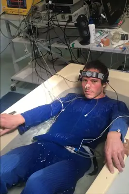 A research participant instrumented with multi-site skin-temperature sensors during a heat-stress study