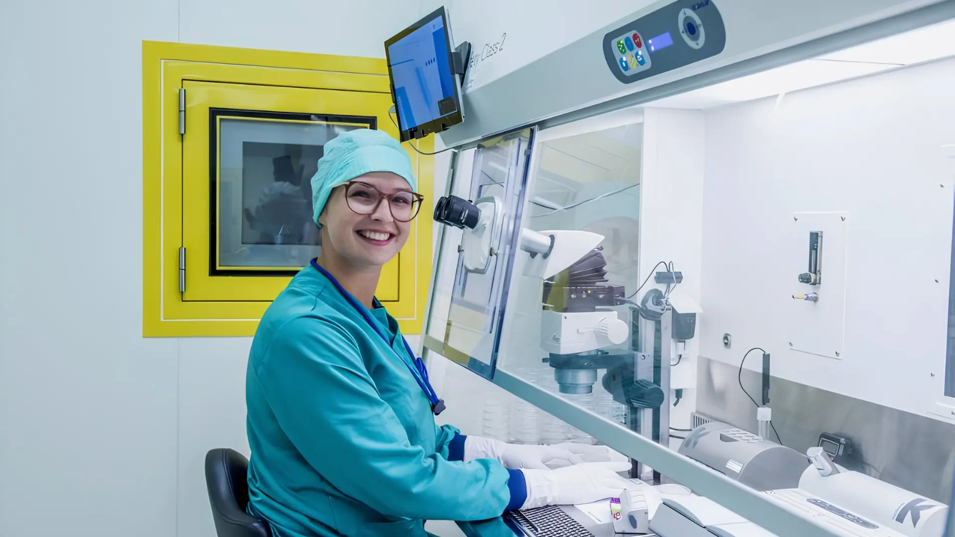 A close, careful laboratory procedure under magnification in a fertility clinic, the kind of irreplaceable, time-critical work continuous environmental monitoring protects