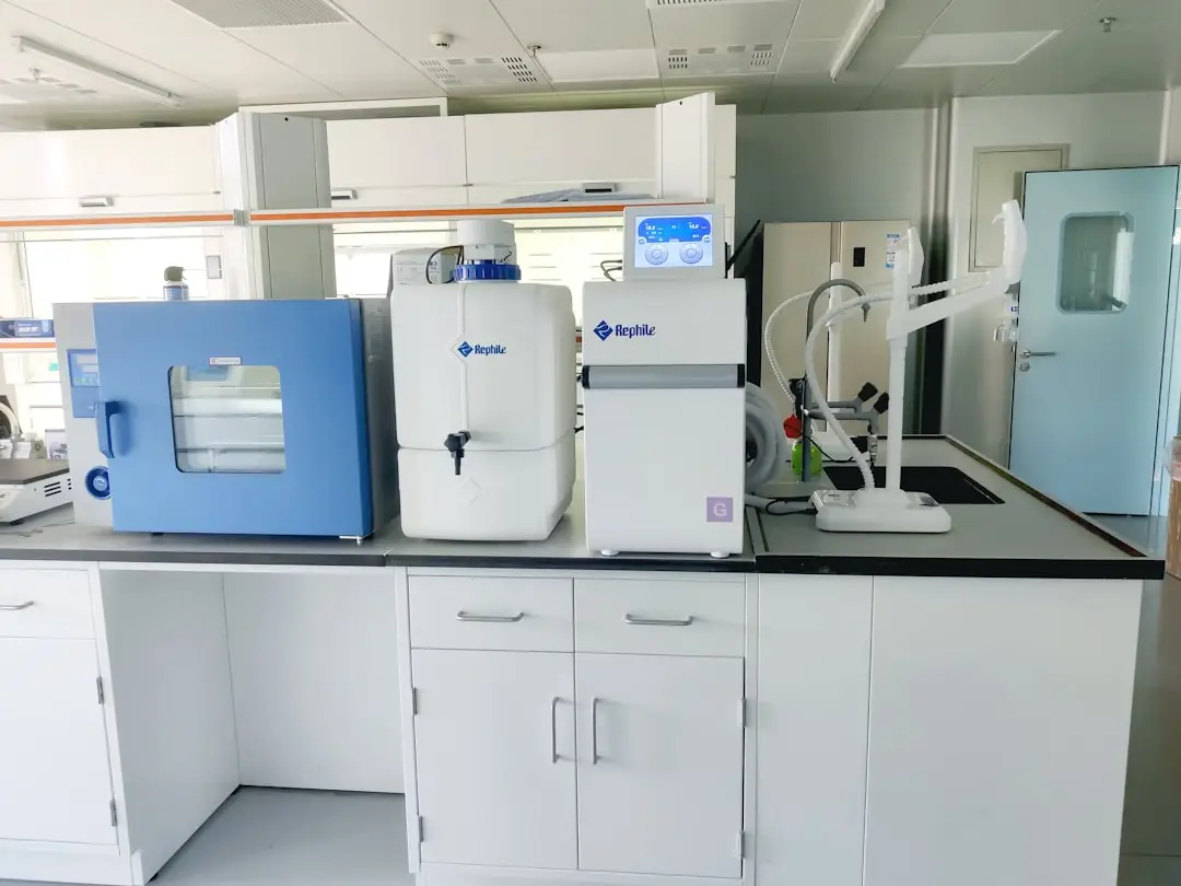 A laboratory bench of temperature-controlled equipment — a benchtop chamber and lab units with digital readouts — the kind of freezers, incubators and chambers Eltek monitors continuously