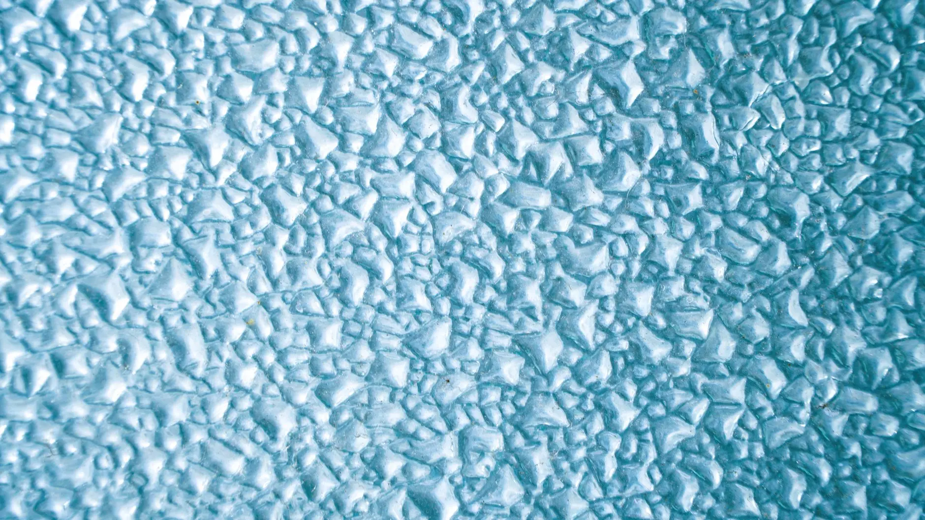Frost and ice crystals building up across a cold surface, a common early warning sign of a freezer beginning to struggle