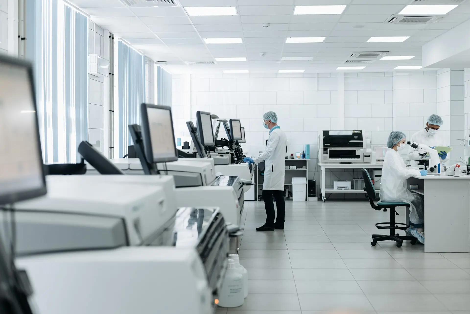 A modern environmental-monitoring laboratory with analytical instrumentation and technical staff at work, illustrating the regulated environments Eltek partners serve