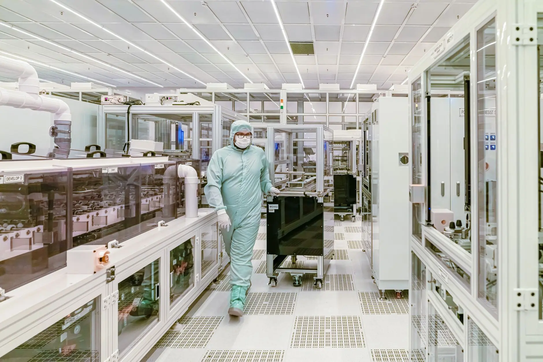 A gowned operator in a controlled GMP cleanroom, the kind of regulated, audit-critical environment Eltek monitors continuously for temperature, humidity and data-integrity compliance
